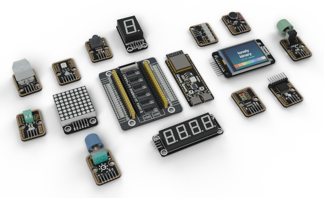 An ESP32-S3 Gold Edition beside its PinPulse shield, with TinkerBlock modules from the kit around them: a colour TFT screen, an 8x8 LED matrix, 7-segment displays and sensors on black and gold boards.